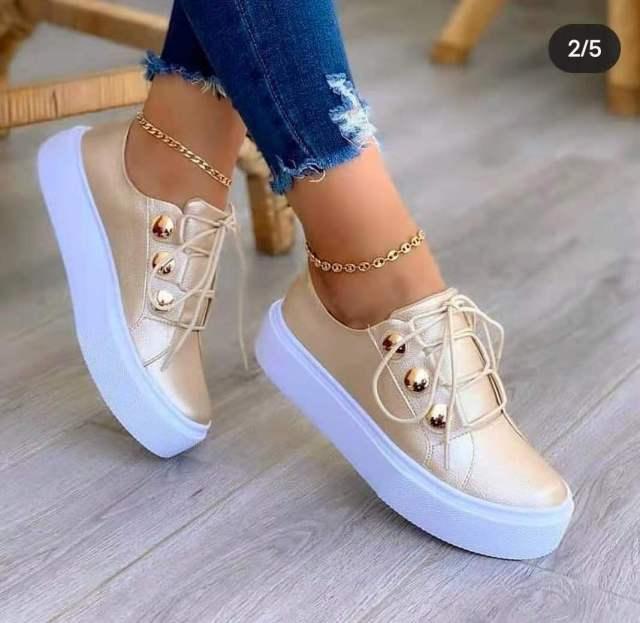Women's gold and white platform sneakers with round toe and lace-up closure