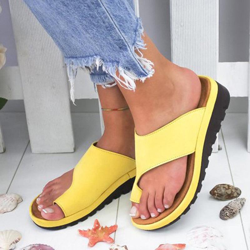 Women wearing stylish leather platform toe-ring sandals on a sunny beach