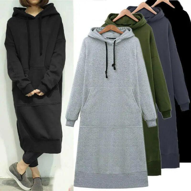 Model wearing an oversized casual long hoodie sweatshirt dress with drawstring hood and pouch pockets.