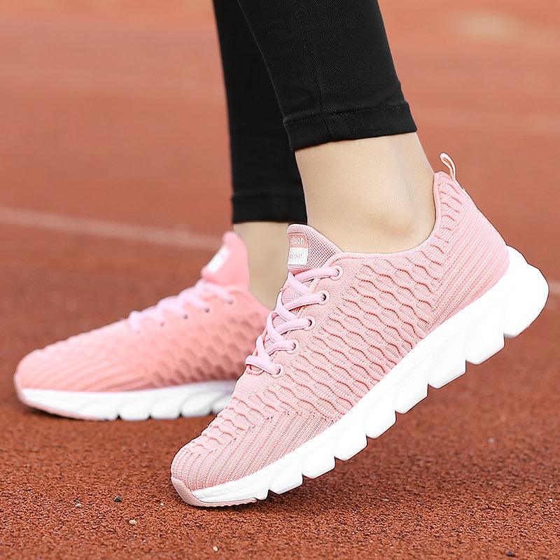 Women's lightweight breathable knit running sneakers in pastel pink with white soles