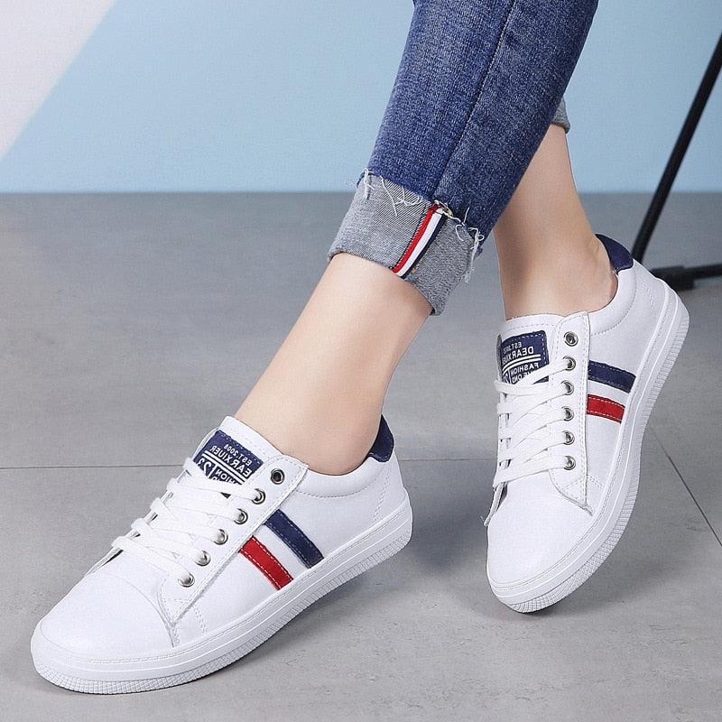 A pair of clean white water-resistant leather casual sneakers for women