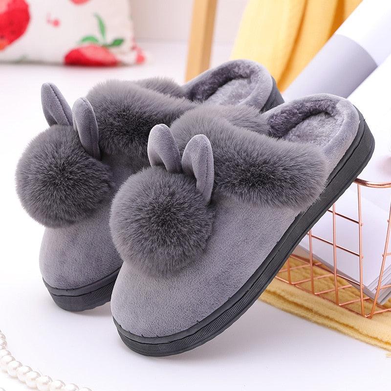 Women's cozy rabbit ear indoor slippers in dusty rose featuring a plush fabric finish and thick-bottomed sole.