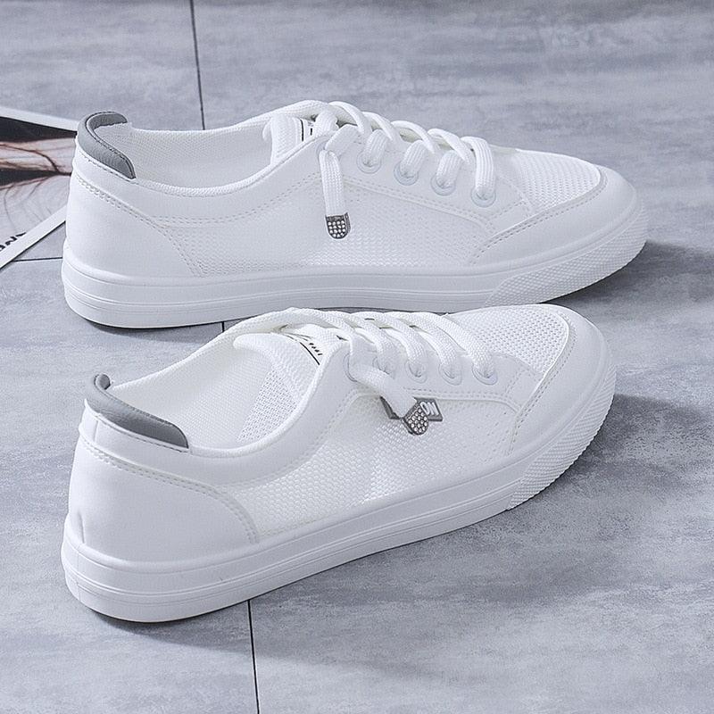 Pair of women's lightweight white mesh casual walking sneakers