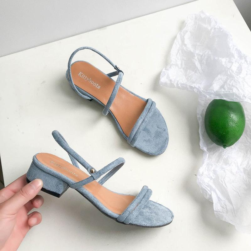 Women's blue open-toe flat sandals featuring an adjustable back strap and casual design