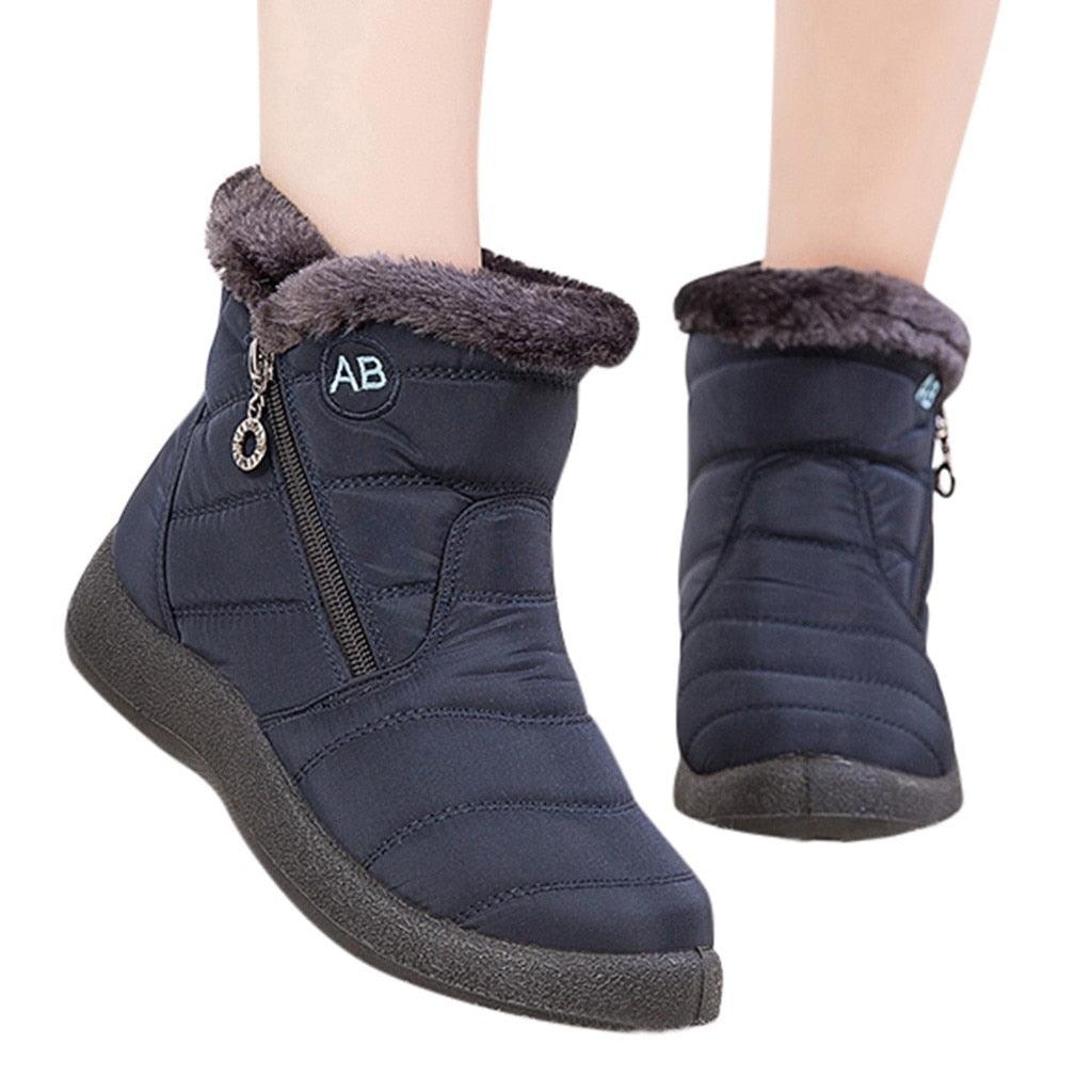Women's cozy fur-lined winter ankle boots in solid color with zip closure