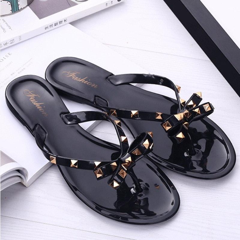 Women's modern flat thong sandals in a slide-on style, perfect for beach and casual summer wear.