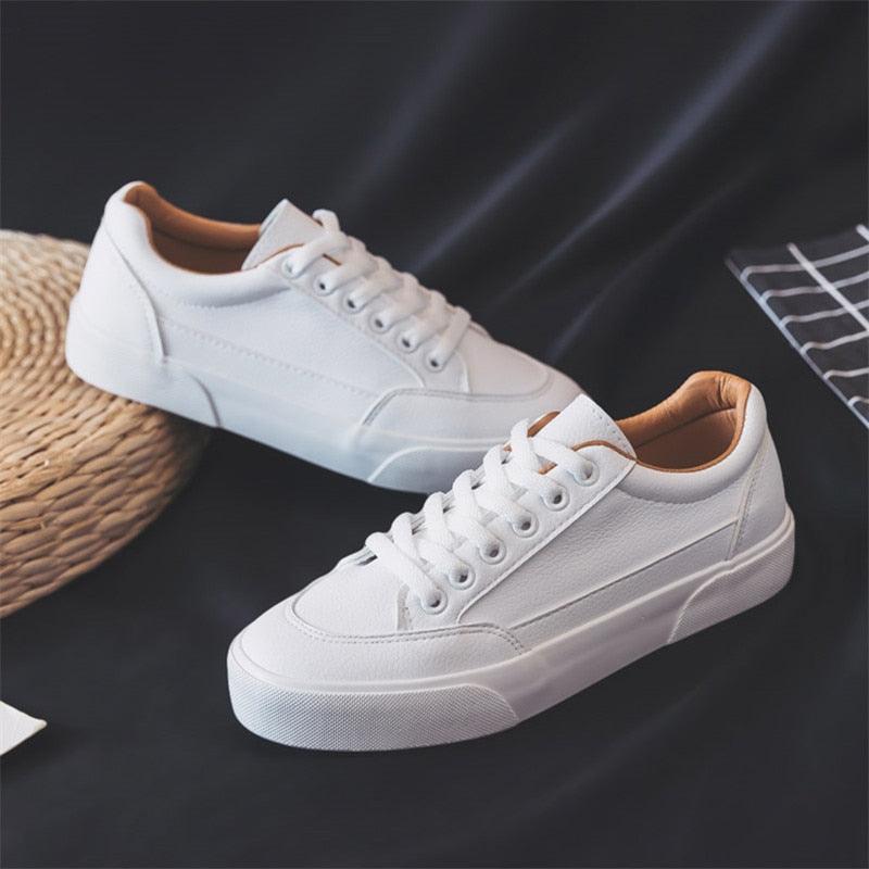 White minimalist business casual sneakers with platform sole for women.
