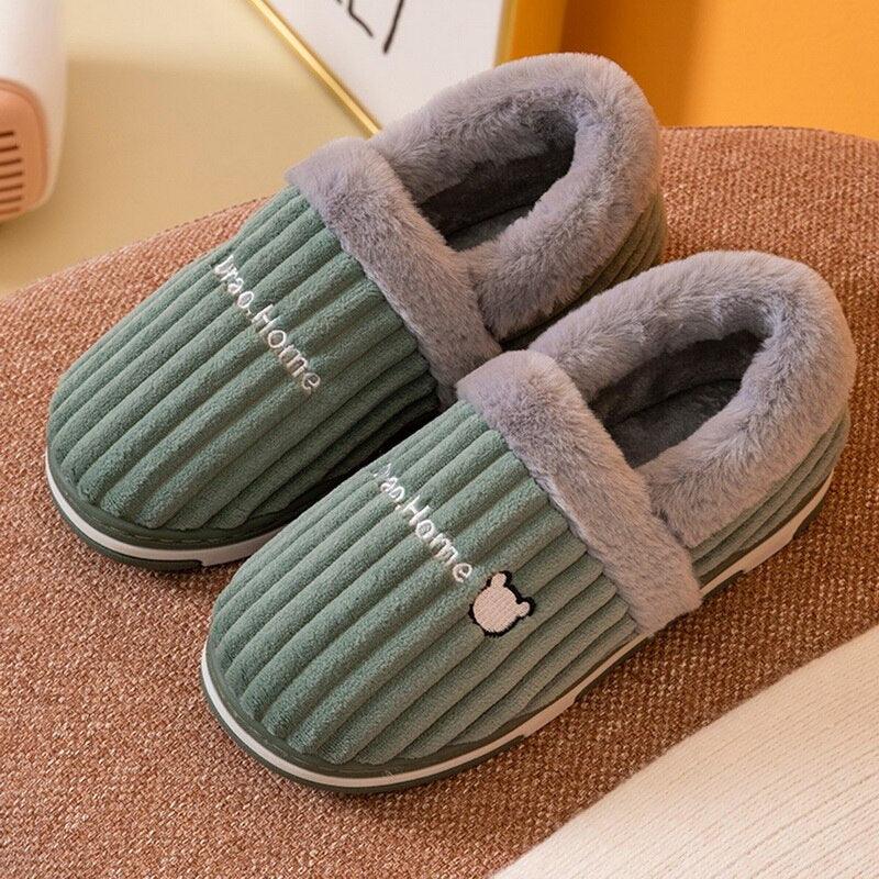 Close up of plush winter house slippers with thick anti-skid rubber soles and memory foam interior