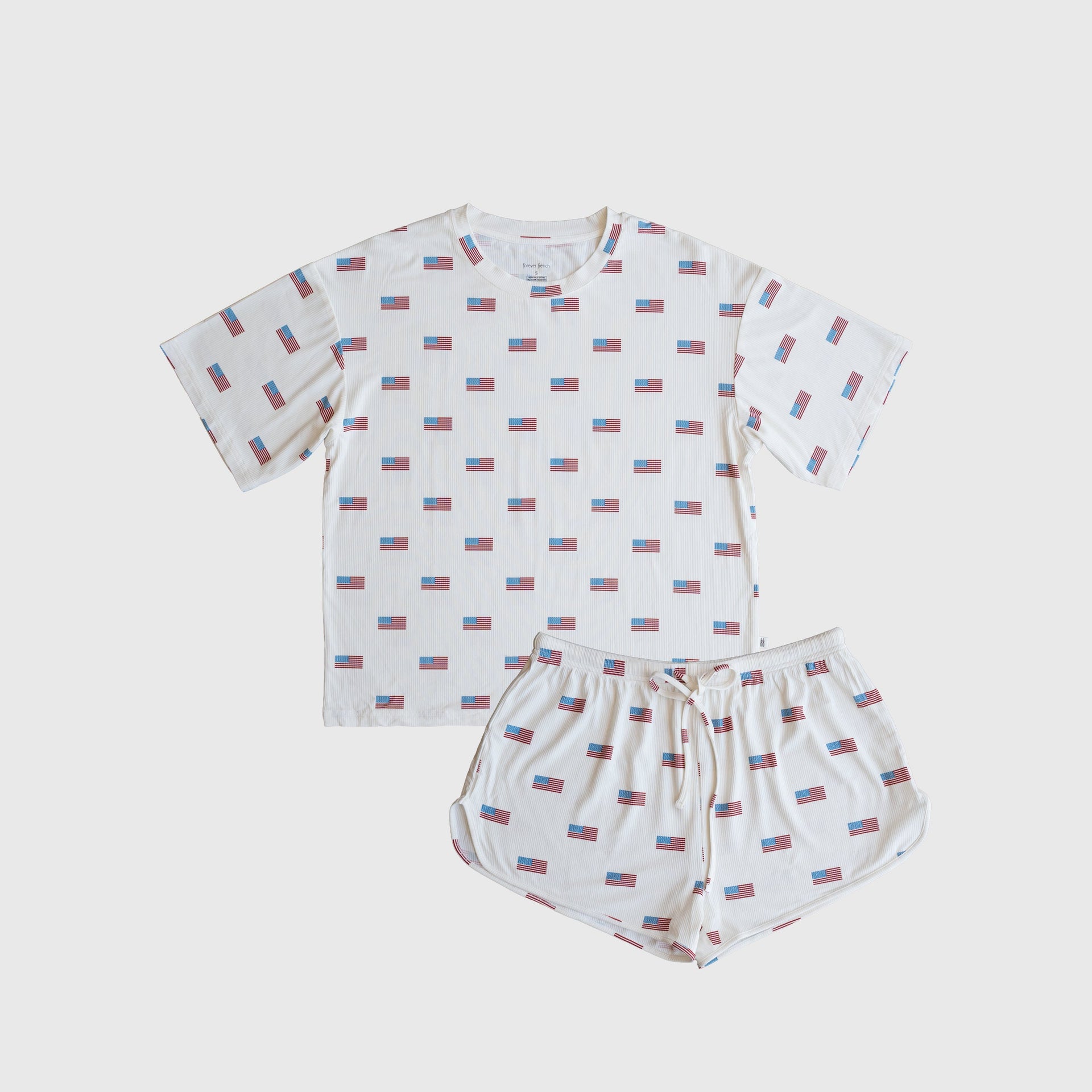 Women wearing a ribbed bamboo short set in Americana red, white, and blue colors featuring an oversized tee and drawstring shorts.