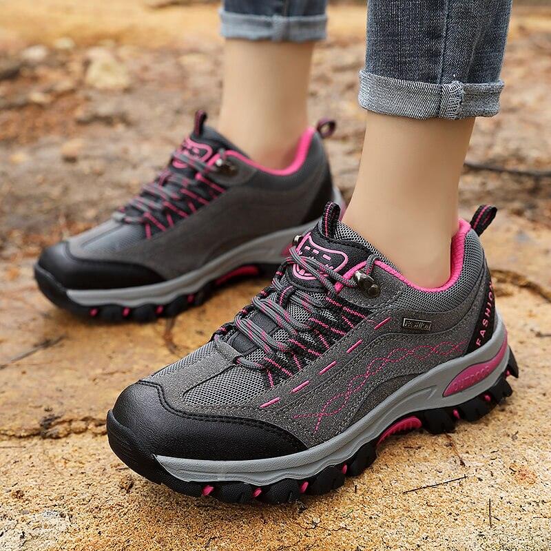 Women's leather hiking ankle boots in grey with neon pink accents, designed for athletic outdoor use.