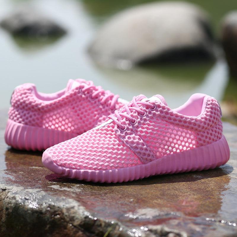 Women's lightweight mesh walking sneakers in solid pink, white, and black
