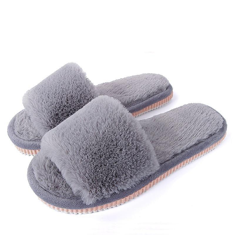 A pair of comfortable women's plush faux fur house slippers in heather grey, purple, and red with an EVA sole.