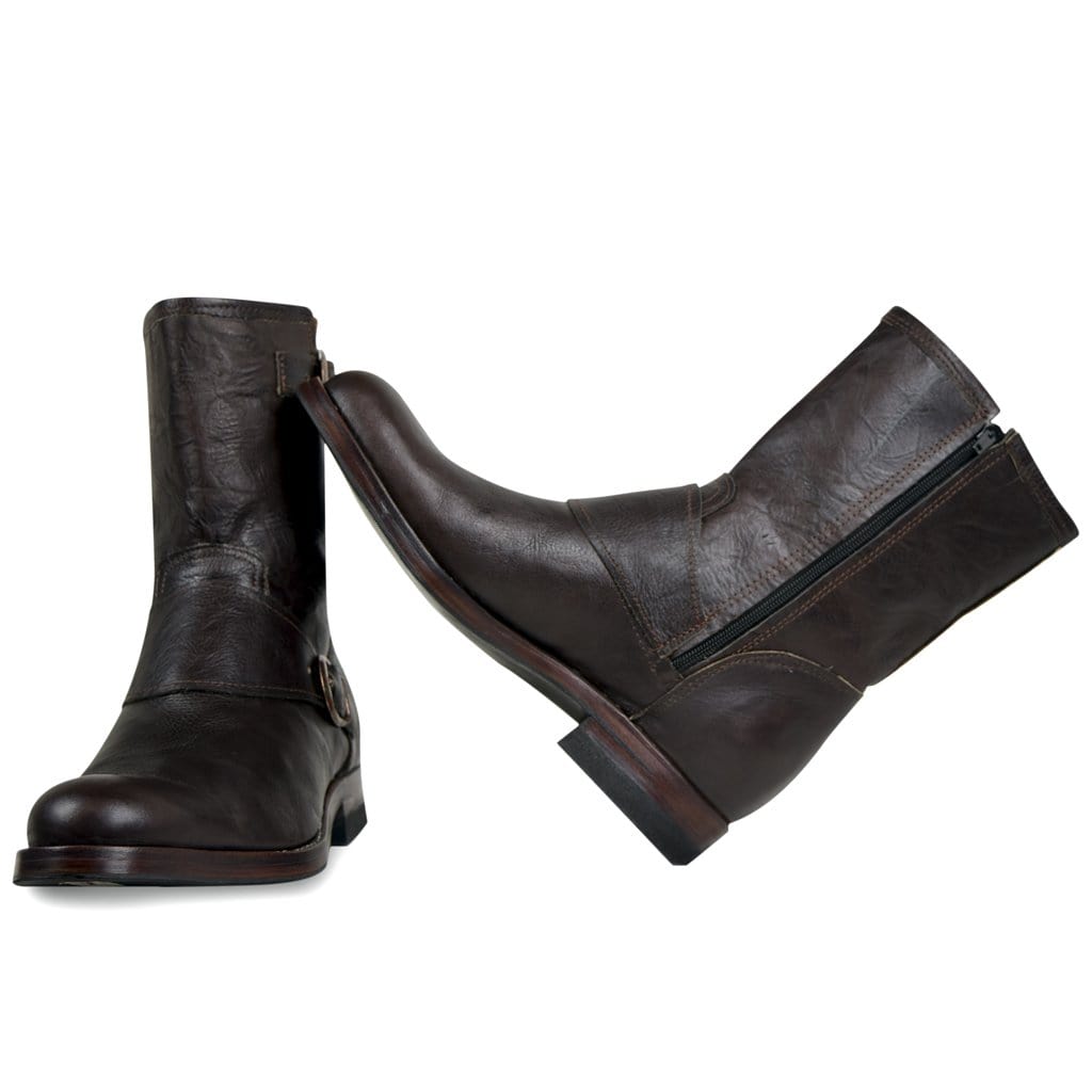 A pair of brown handmade leather biker boots with buckle detail and side zipper closure on a white background