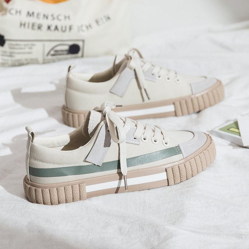 Women wearing comfortable striped canvas slip-on casual flats with elastic band detail