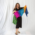 Beautiful crochet summer wrap with a wave-inspired texture draped over a beach chair.