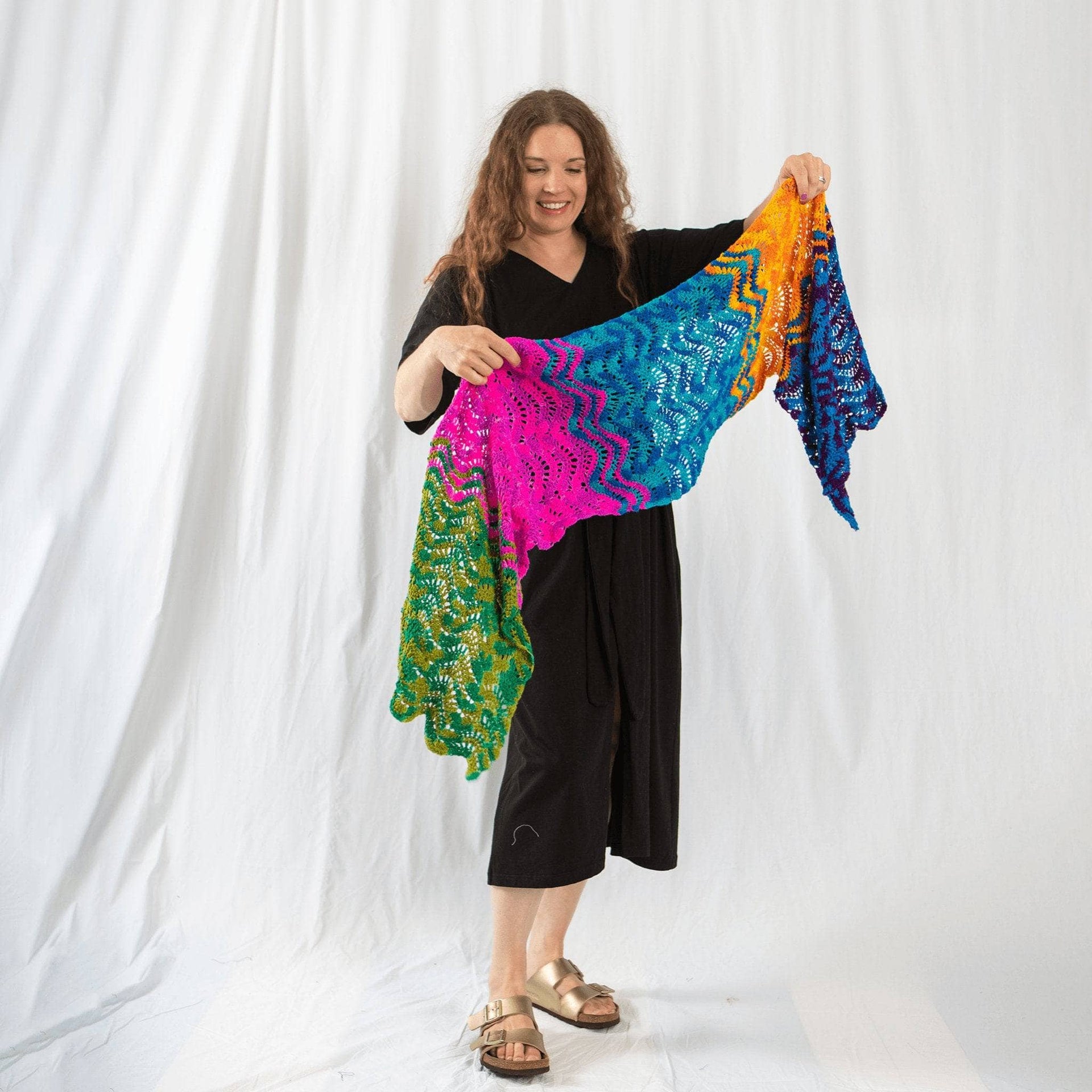 Beautiful crochet summer wrap with a wave-inspired texture draped over a beach chair.