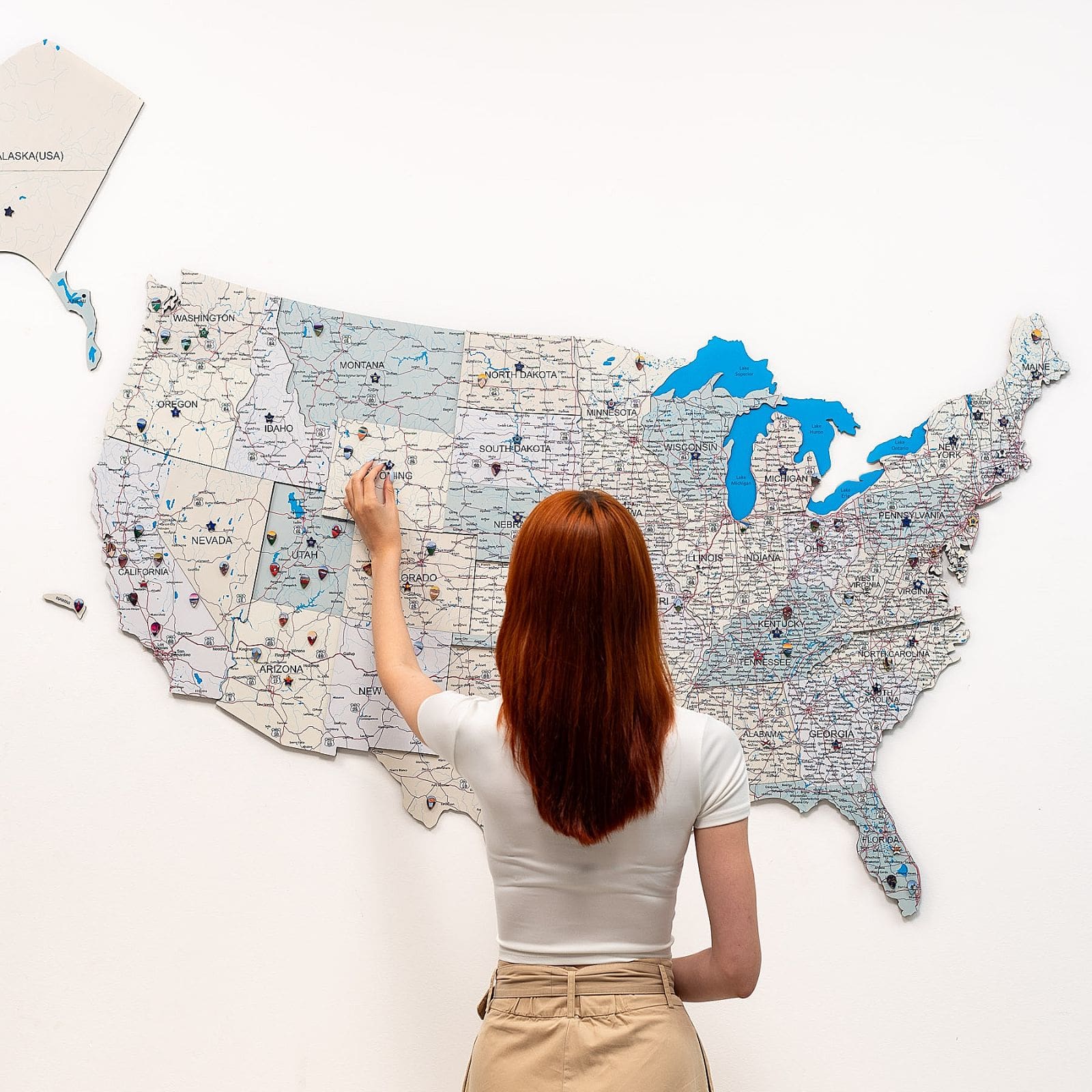 Wooden USA wall map with beige and blue details on a neutral background