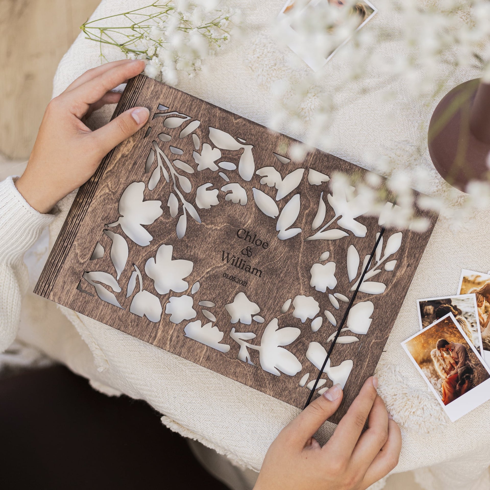 Close up of the Floret Wooden Photo Album featuring a laser-etched floral design on natural wood.