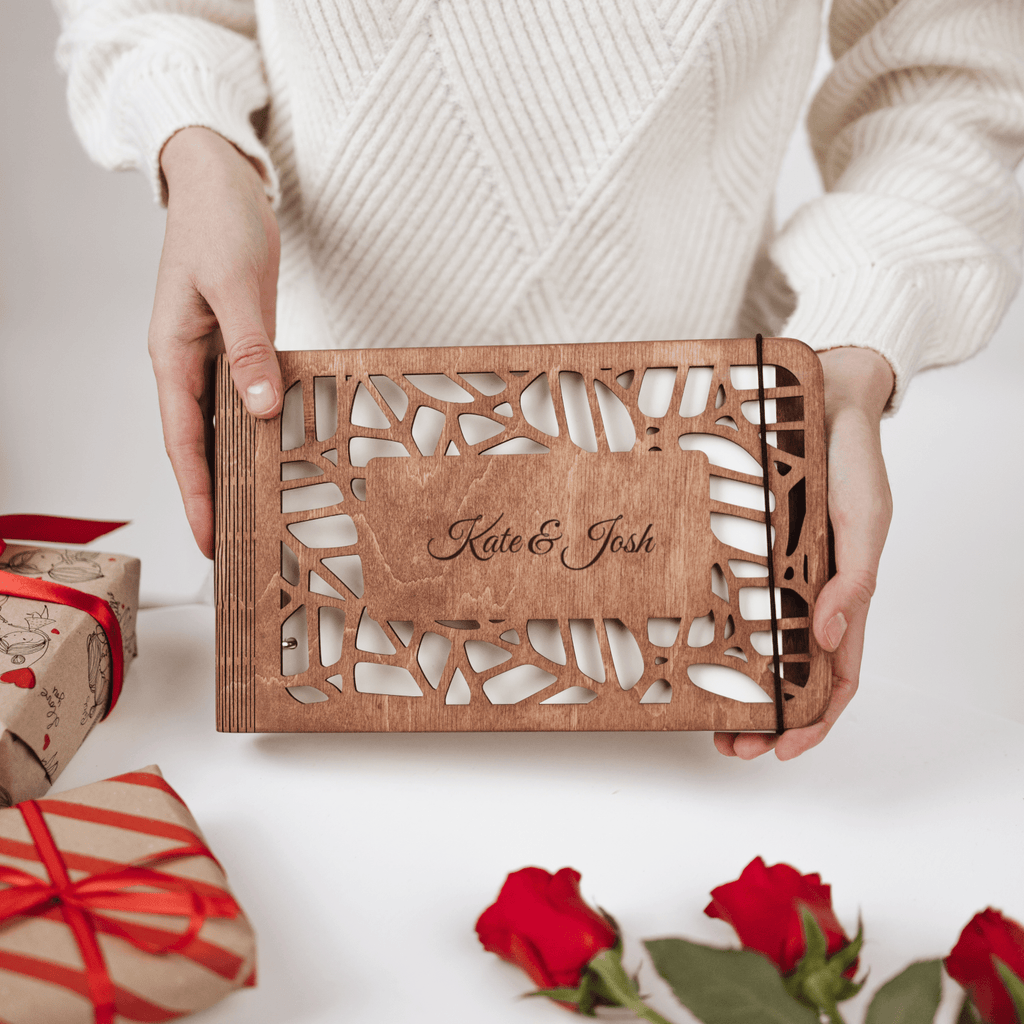 Personalized wooden photo album in natural wood finish resting on a minimalist table