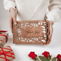 Personalized wooden photo album in natural wood finish resting on a minimalist table