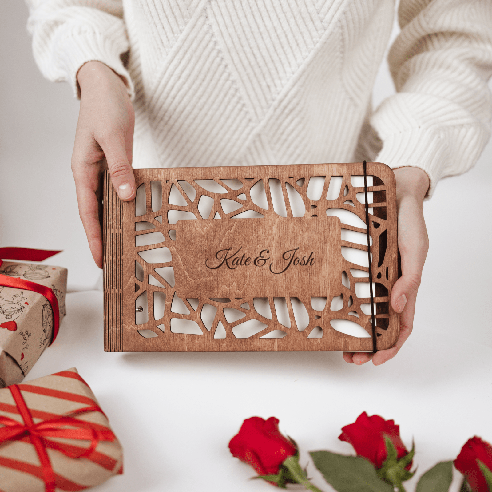 Personalized wooden photo album in natural wood finish resting on a minimalist table
