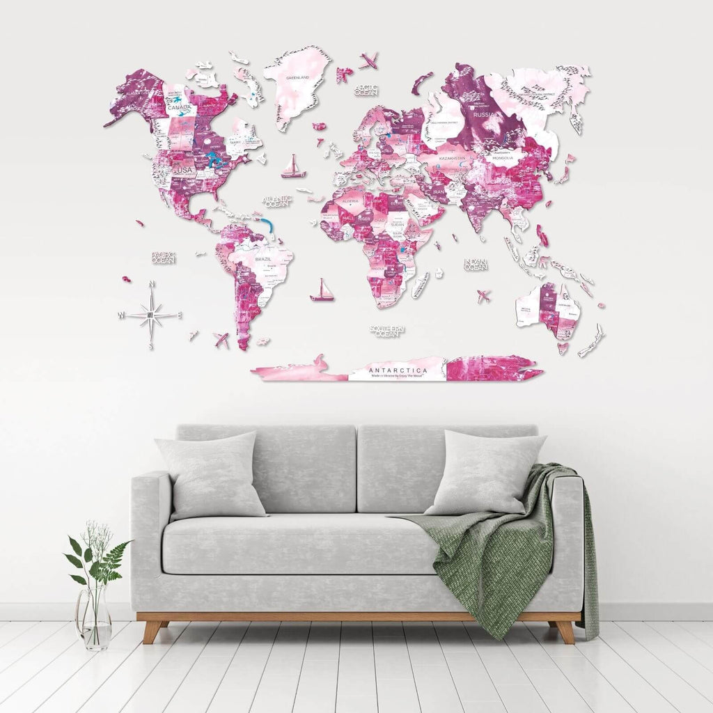 Large-scale 3D wooden world map wall art in ombré magenta, hot pink, and white tones.