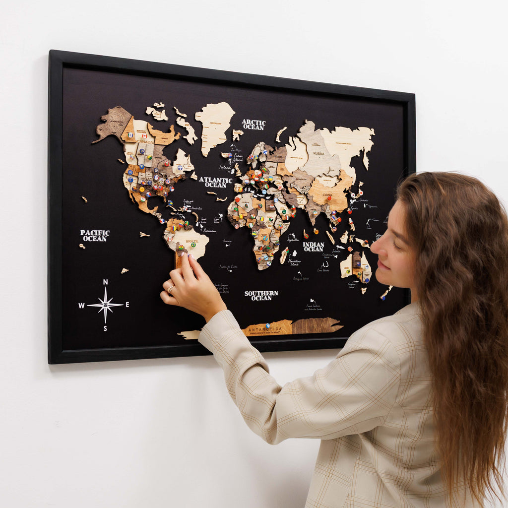 A decorative 3D wooden panel world map featuring brown, beige, and black tones on a living room wall.