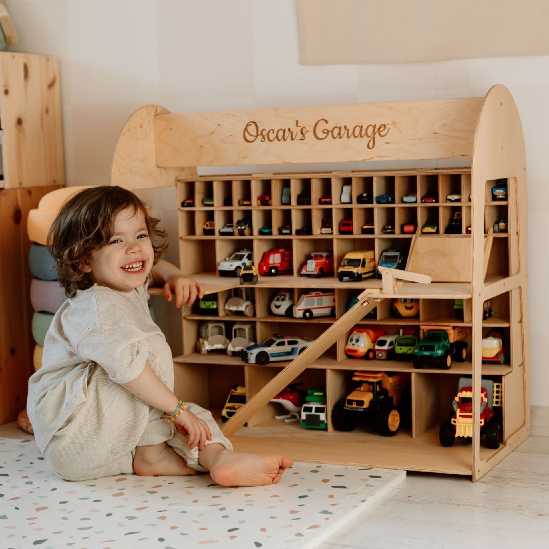 Minimalist wooden toy car garage organizer in a neutral room setting
