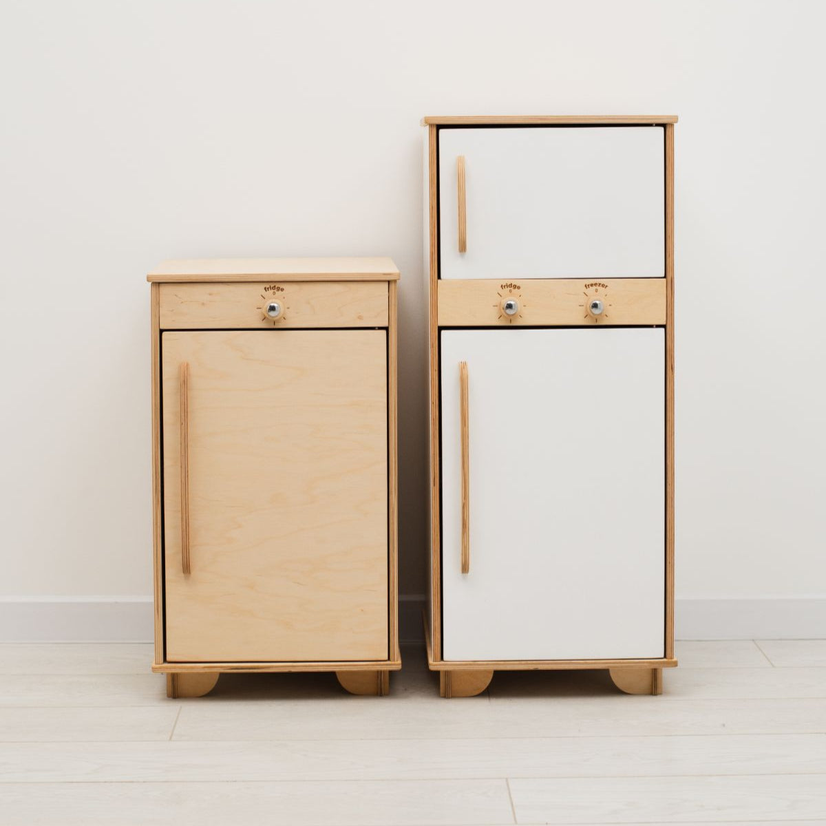Minimalist scandi-style wooden play fridge for children in a bright playroom