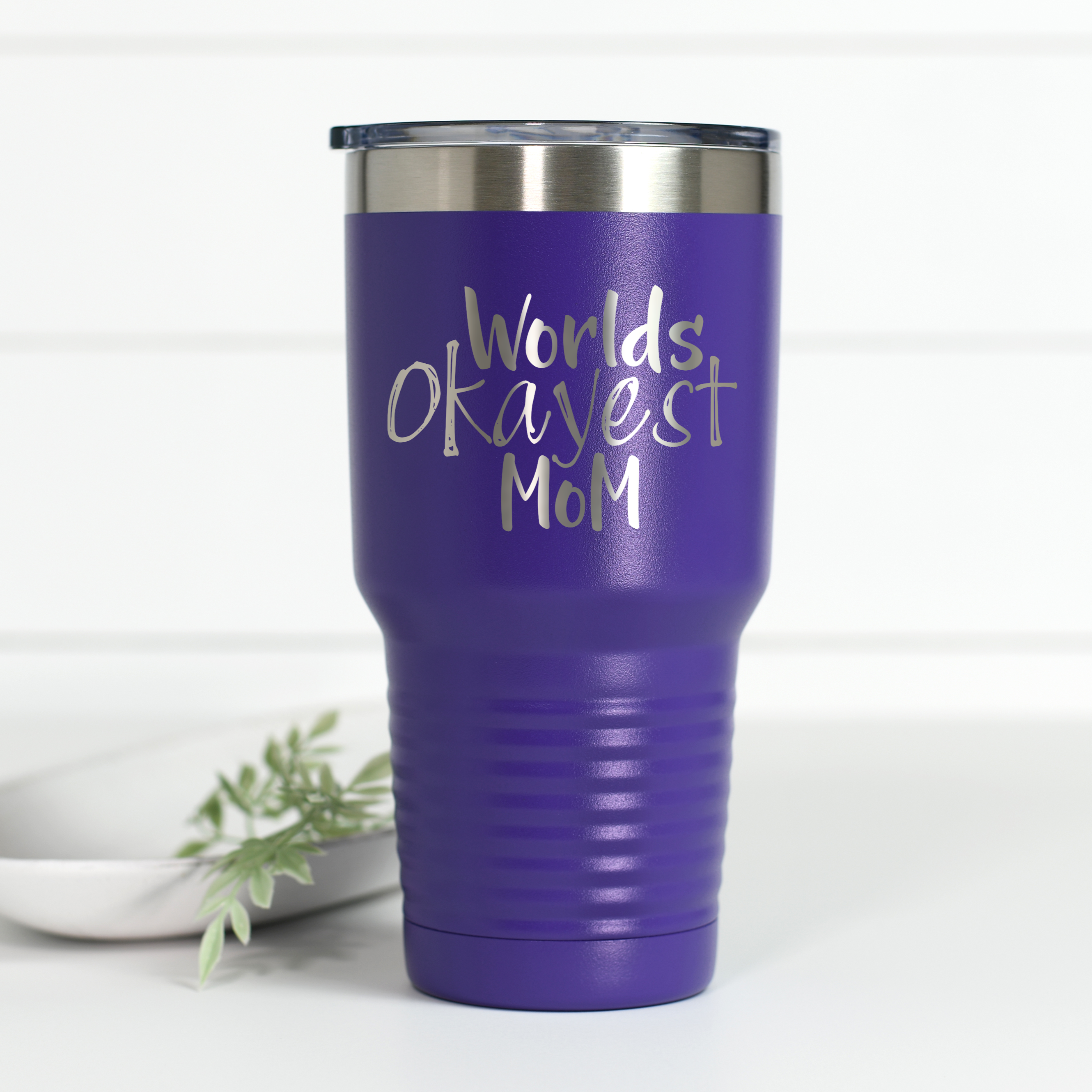 Purple 30 oz stainless steel tumbler engraved with the text World's Okayest Mom