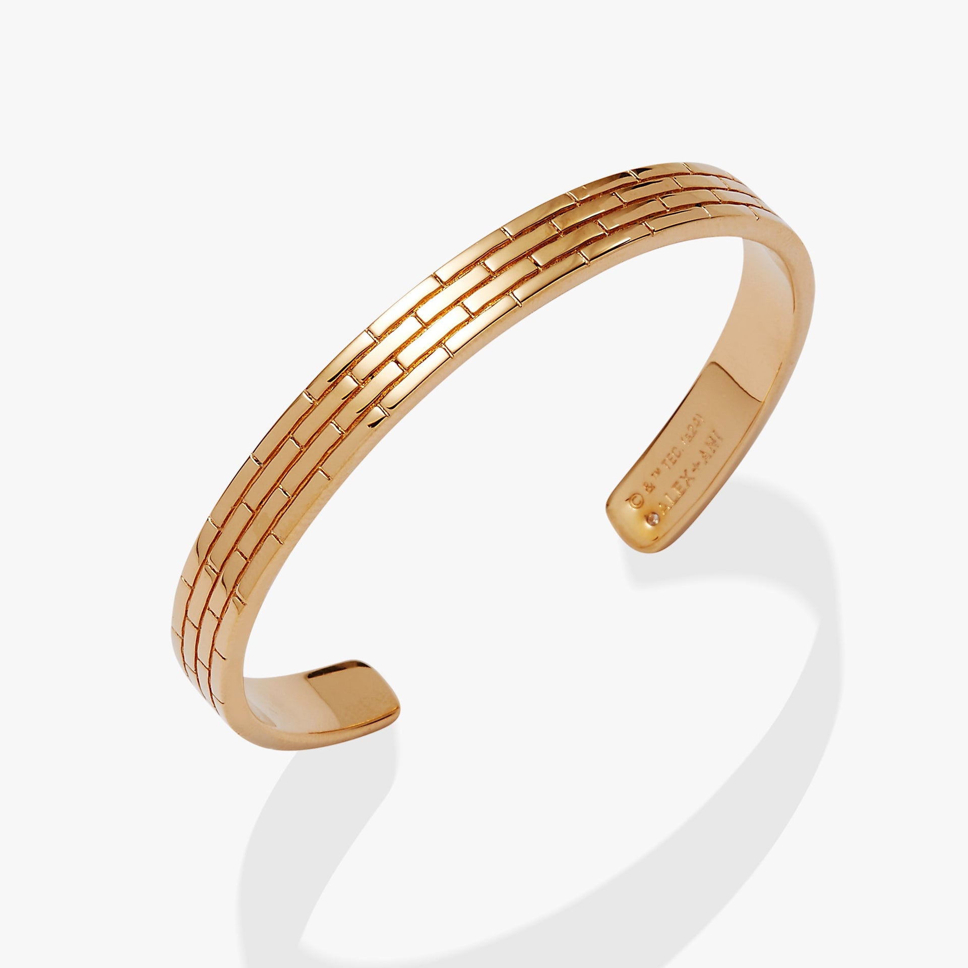 Alex And Ani Wizard of Oz Yellow Brick Road cuff bracelet with textured brick design and inner engraving.