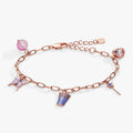 The Wizard of Oz Good Witch charm bracelet with crown, wand, butterfly, and pink heart crystal charms.