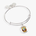 Silver-tone bangle featuring a resin-topped charm of Dorothy and her friends on the path to Oz.