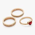 A set of three stackable rings featuring a golden brick texture, a red crystal heart, and a 'There's no place like home' inscription.