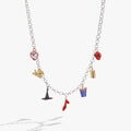 The Wizard of Oz charm necklace featuring ruby slippers, Toto, and golden brick charms on a silver and gold tone chain.
