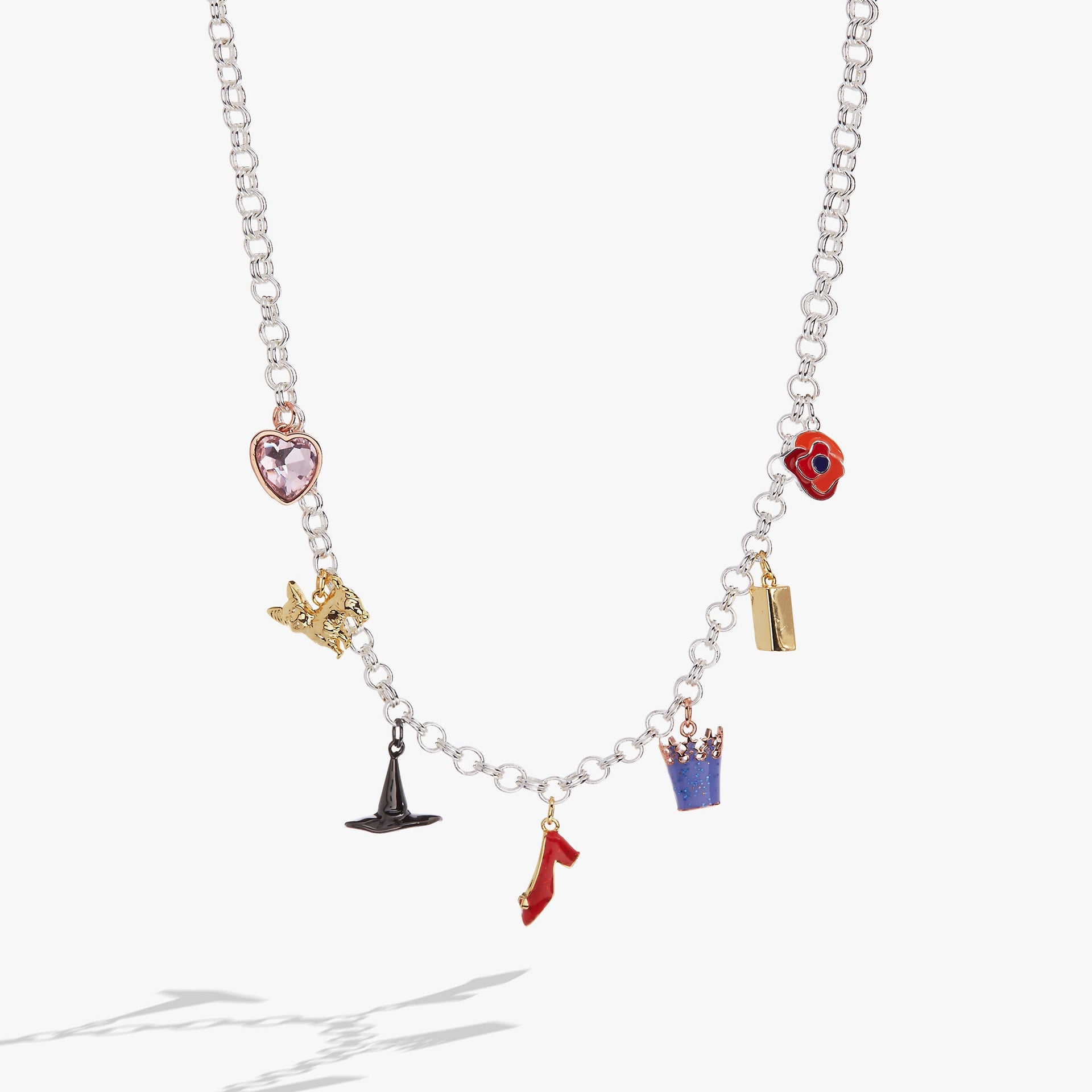 The Wizard of Oz charm necklace featuring ruby slippers, Toto, and golden brick charms on a silver and gold tone chain.