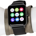 A grey EMF protection wrist band worn under a black smartwatch on a white mannequin wrist.