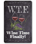 WTF Wine Time Finally metal sign featuring two wine glasses and grapes in a chalkboard design style.