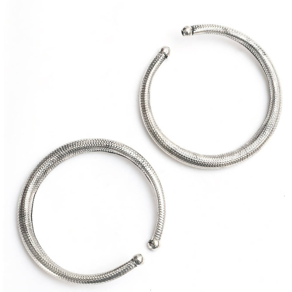 A pair of traditional oxidised silver anklets with intricate Kamal Johar design