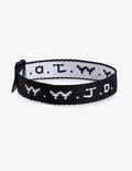 Close up of a colorful W.W.J.D. adjustable bracelet worn on a wrist, showcasing 90s aesthetic