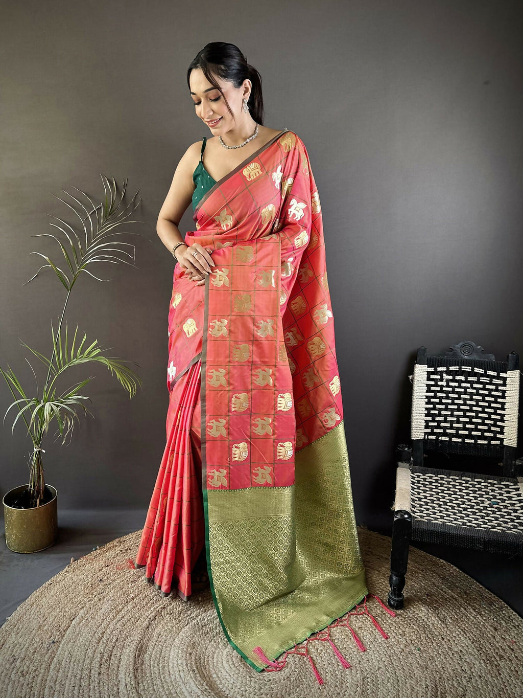 Orange soft silk Banarasi saree featuring elephant motifs with a contrasting green blouse