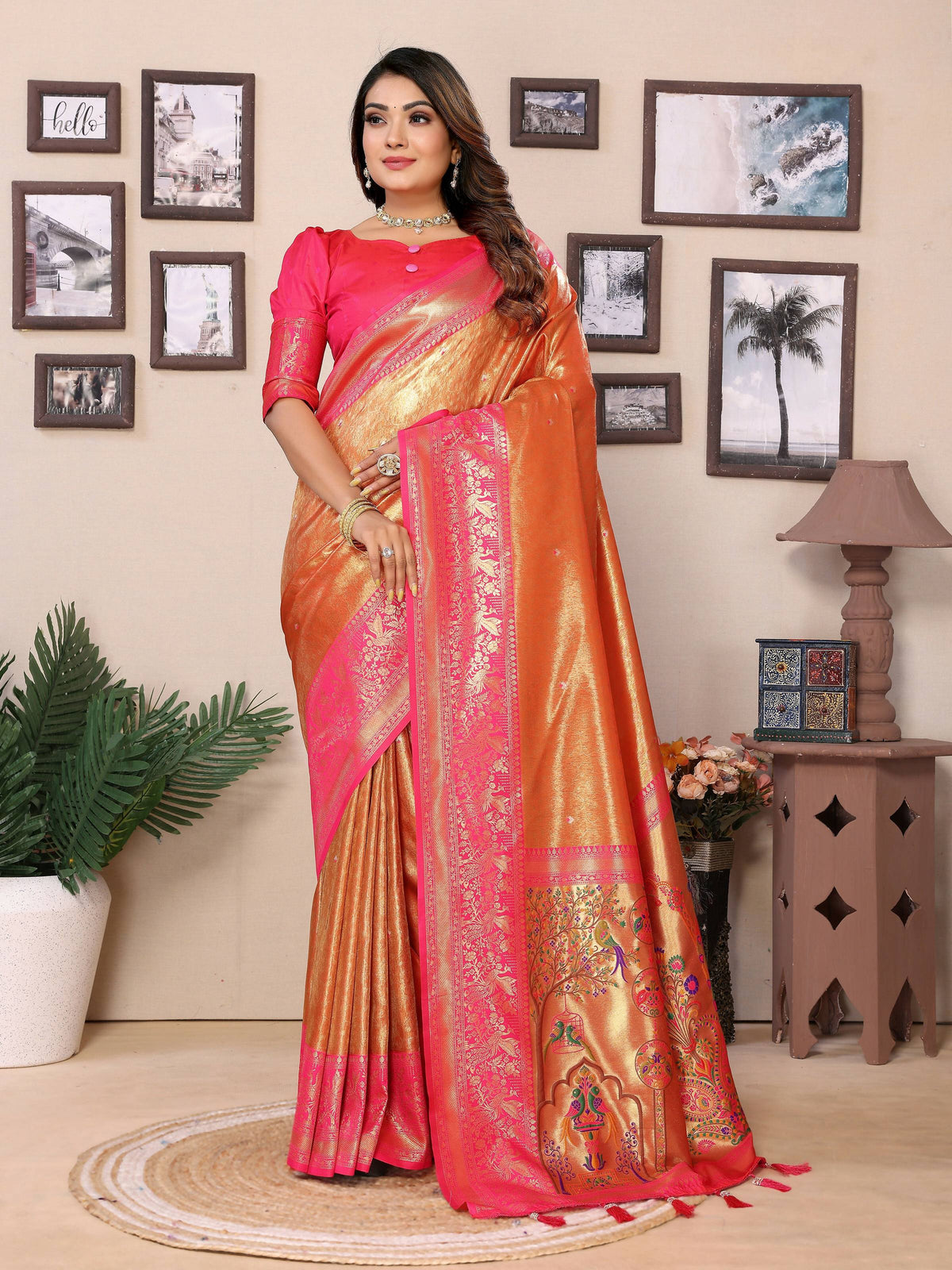 A vibrant orange tissue silk saree with intricate gold weaving patterns
