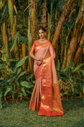 Peach Kanjivaram silk saree with intricate zari work and contrasting red blouse
