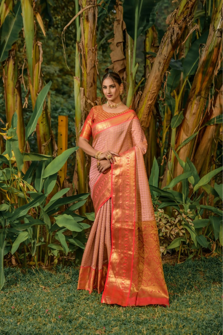 Peach Kanjivaram silk saree with intricate zari work and contrasting red blouse