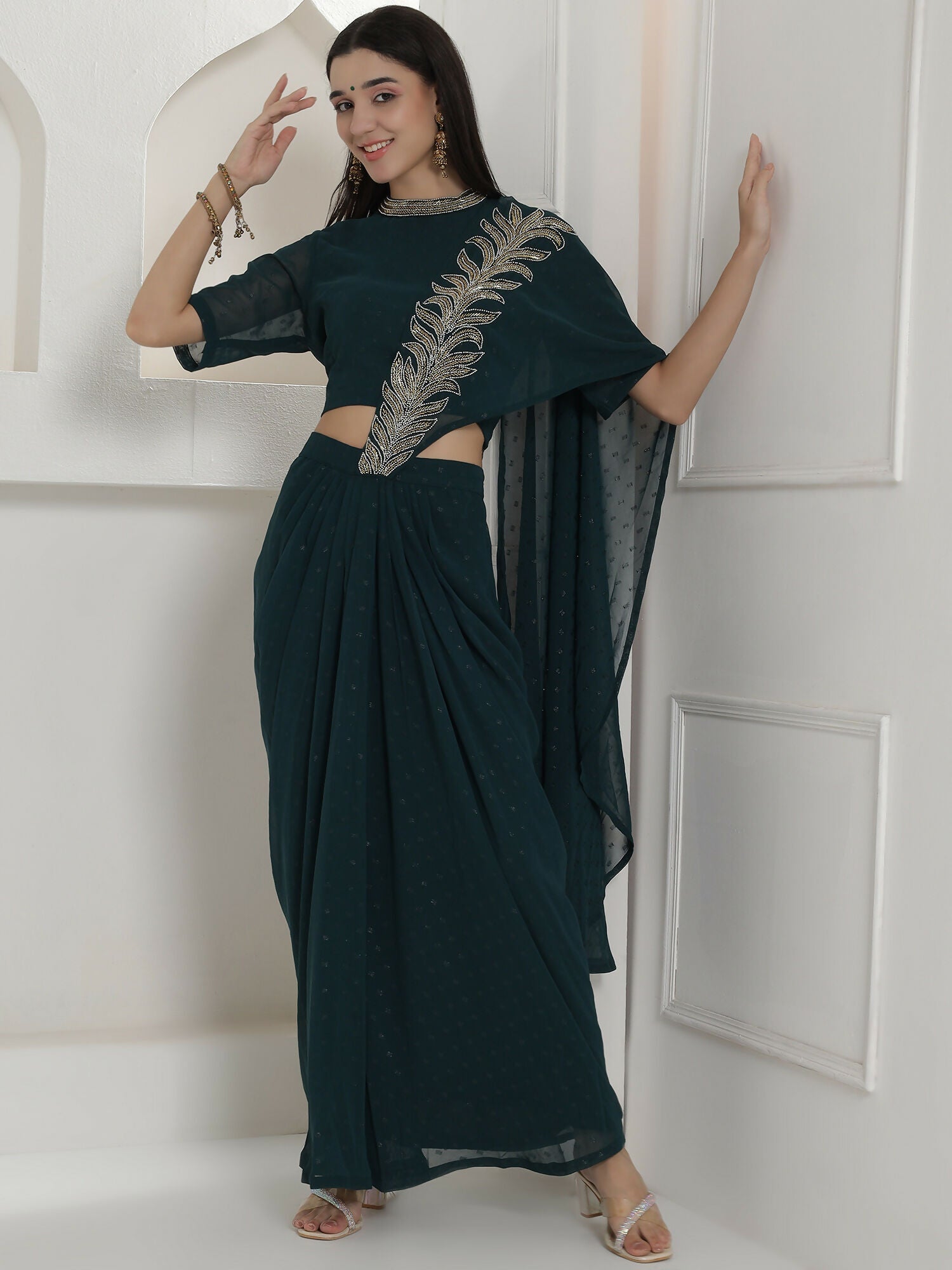 Woman wearing a Joban Fashion green georgette drape skirt set with intricate hand embellishments.
