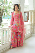A three-piece pink Chinnon kurta set featuring intricate embroidery and sequence work with a net dupatta.