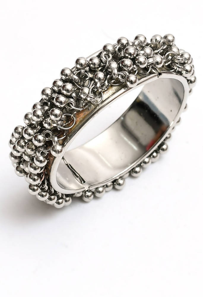 Handcrafted oxidised silver-plated bracelet with ghungroo accents on a neutral background
