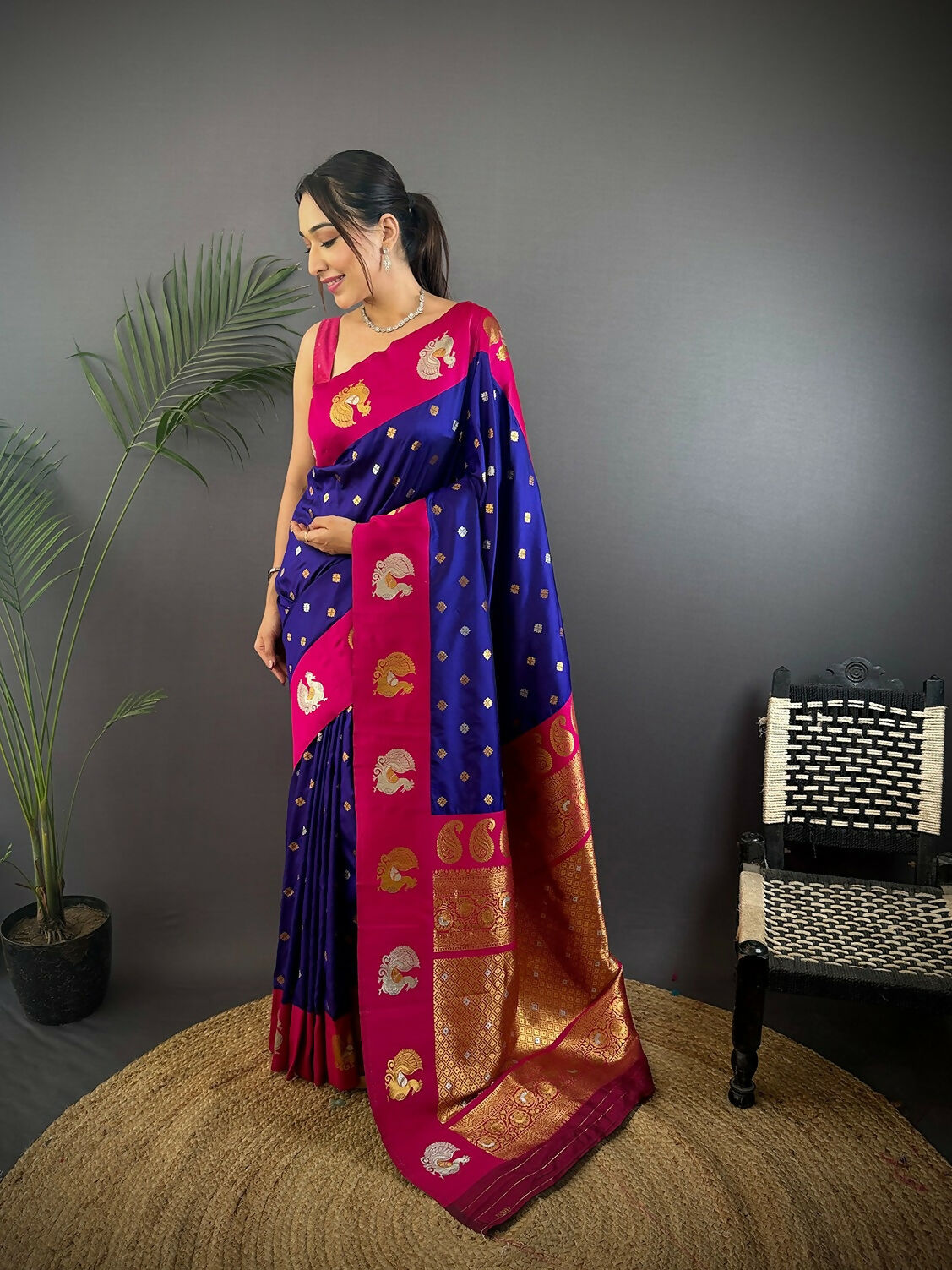 Elegant maroon butti Banarasi silk saree with traditional motifs and matching unstitched blouse fabric.