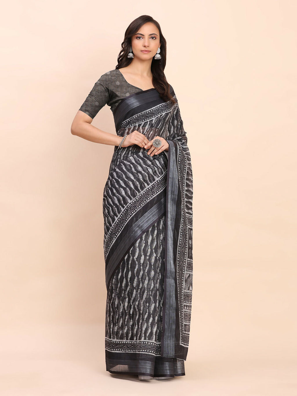Solid black linen cotton saree featuring a minimalist design and matching blouse.