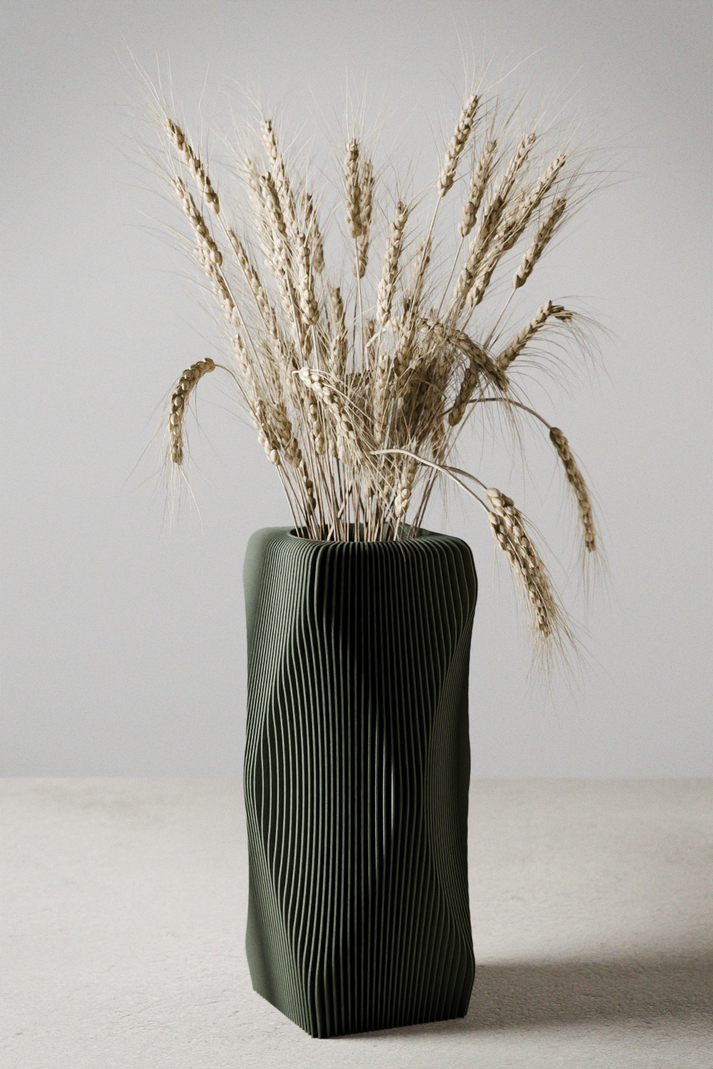 Modern olive green wavy geometric vase filled with dried wheat stalks.